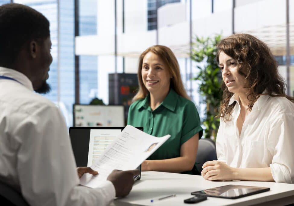 Cheerful HR managers asking interview questions to vet selected applicants and ensure their skills match role needs. Upbeat headhunters in company office assessing candidate work experience